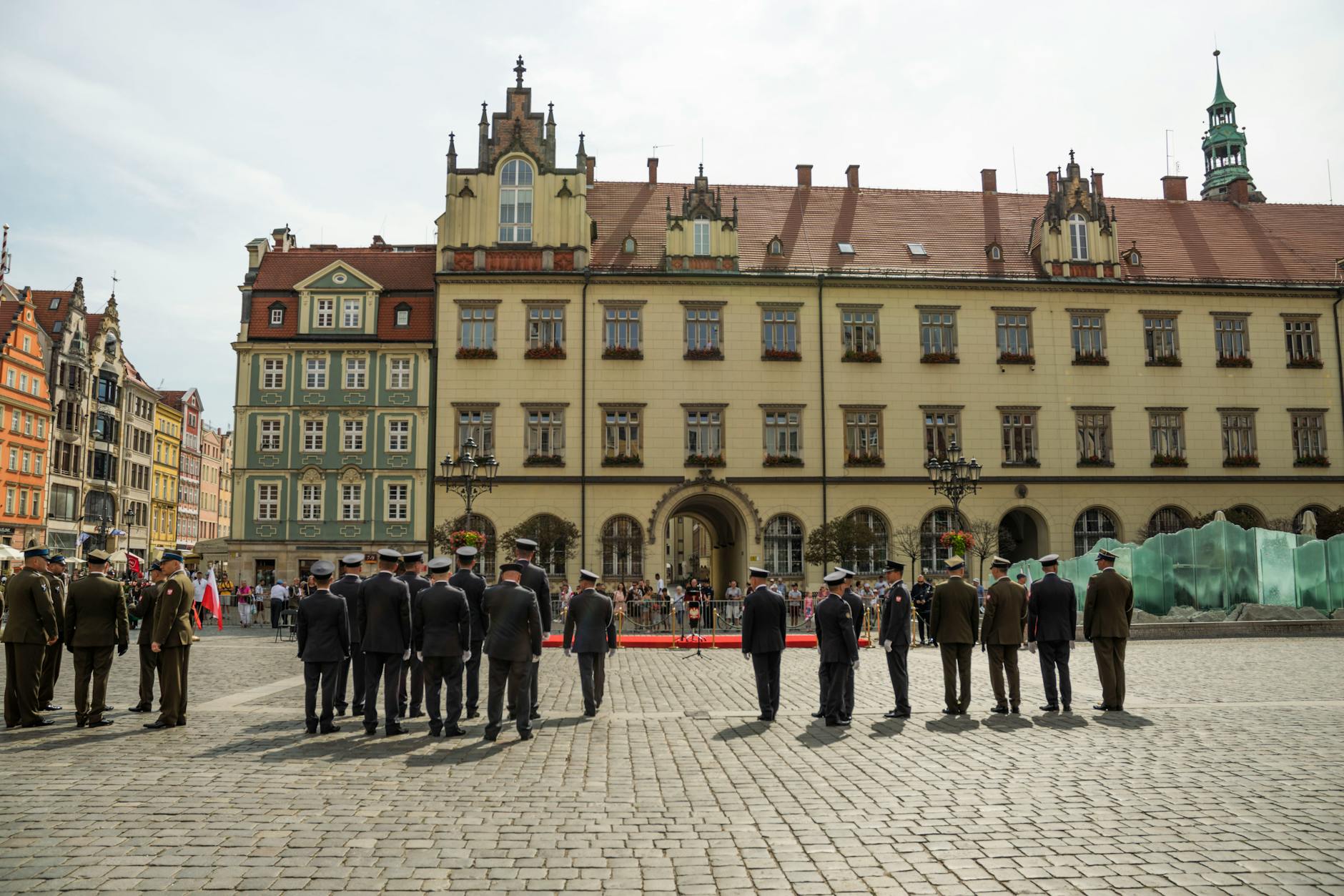 A military ceremony in Wroclaw's Market Square with soldiers standing in formation.
