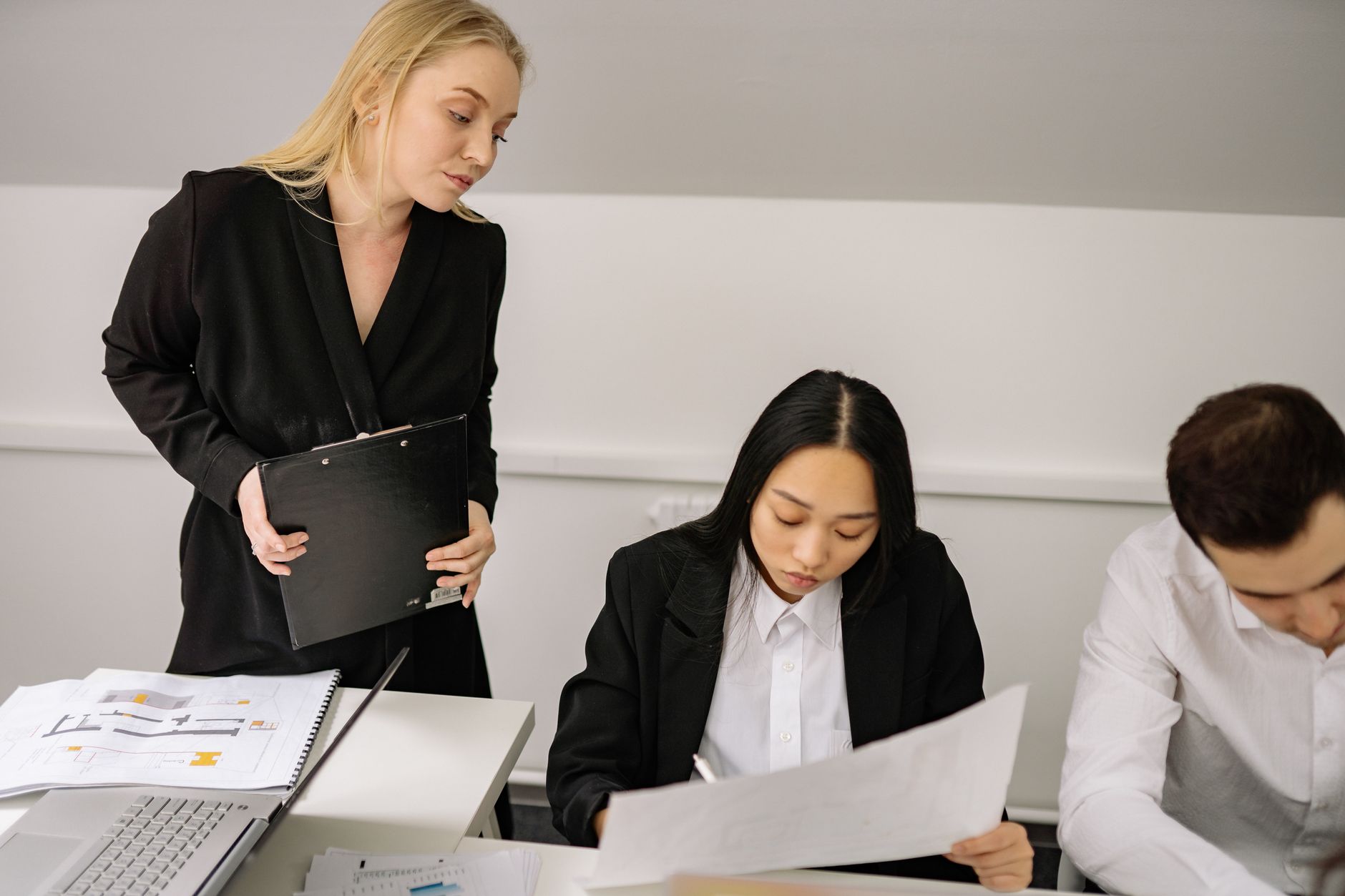 A diverse group of professionals engaged in a discussion during an office meeting.