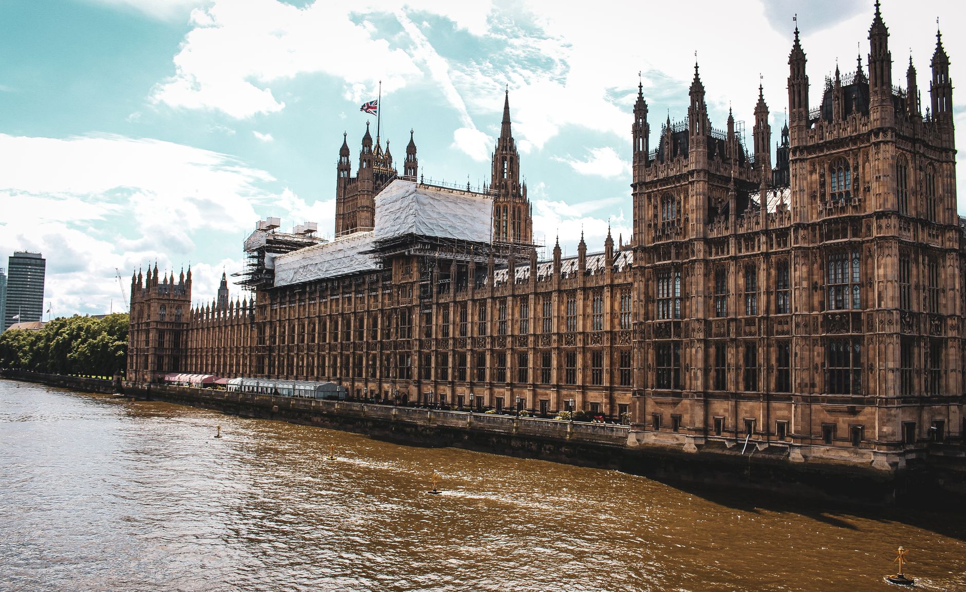 Capture of the iconic Palace of Westminster along the Thames River in London, showcasing Gothic architecture.