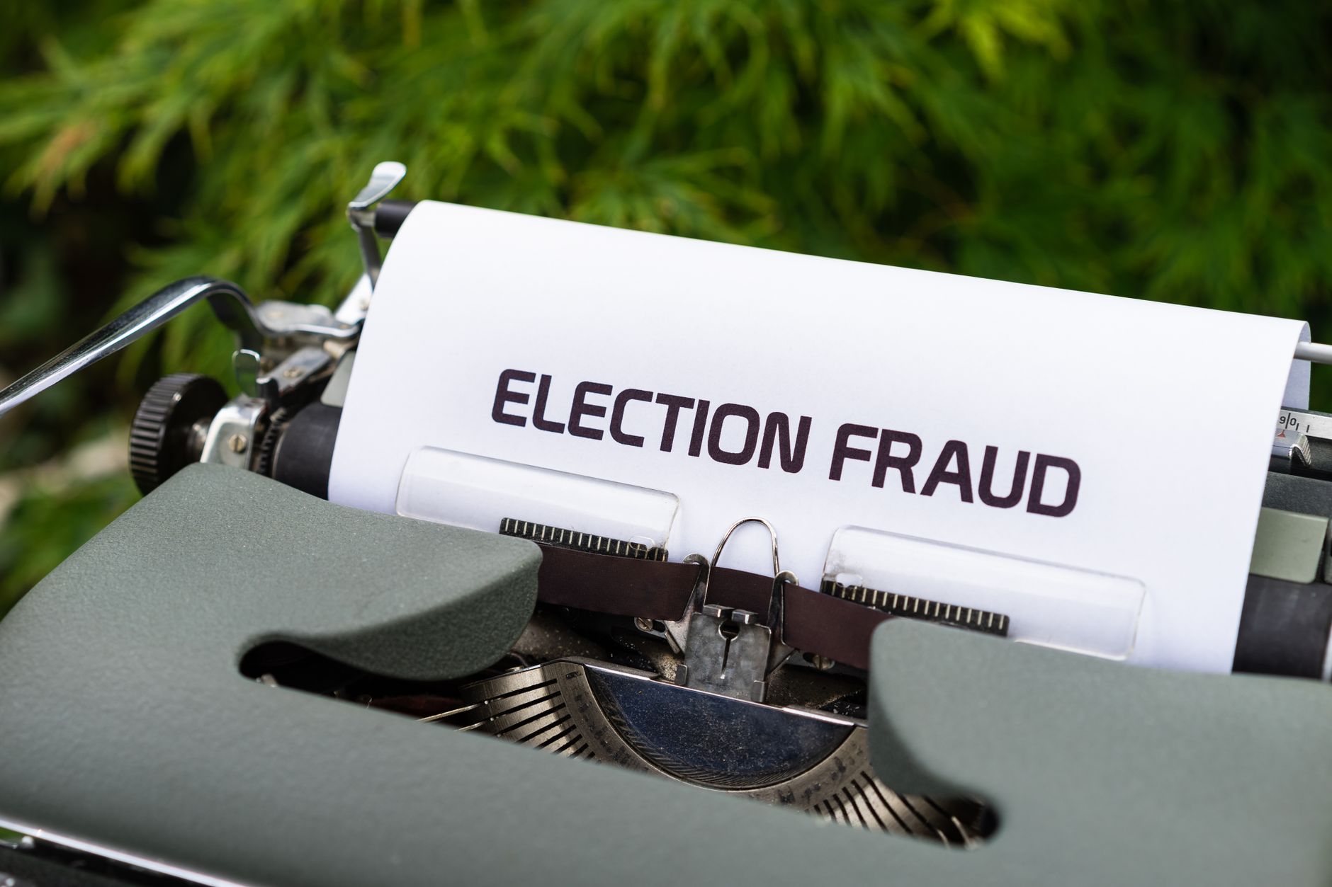 A close-up of a vintage typewriter with a paper displaying 'Election Fraud'. Ideal for themes of politics and nostalgia.