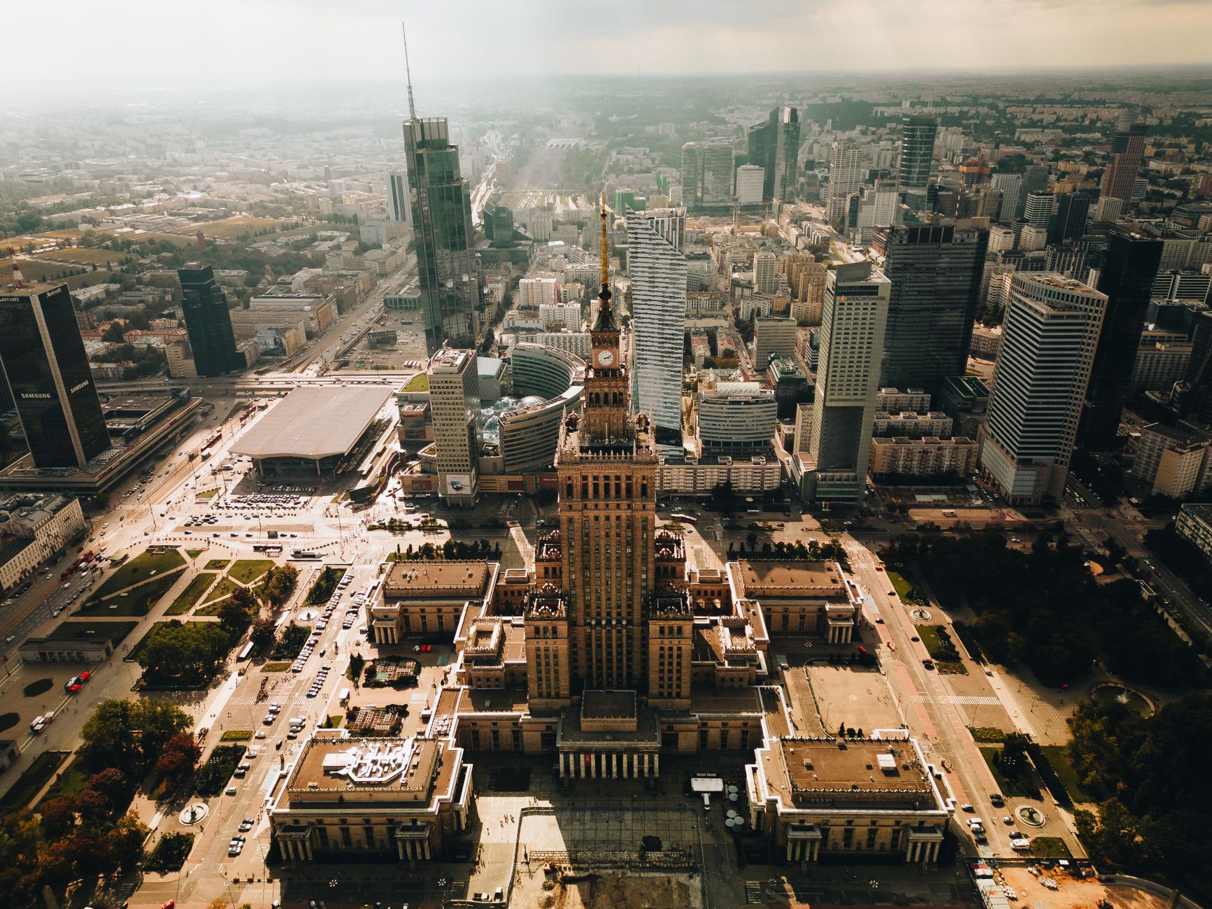 Stunning aerial shot of Warsaw featuring the Palace of Culture and Science amid modern skyscrapers.
