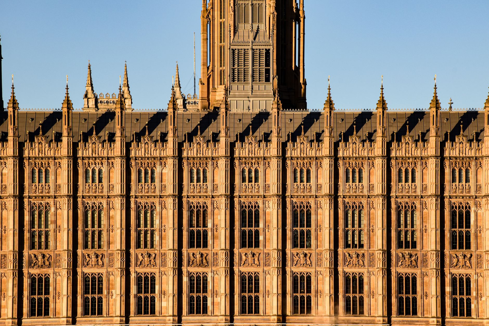 Close-up view of the intricate Gothic Revival facade of the Palace of Westminster in London.