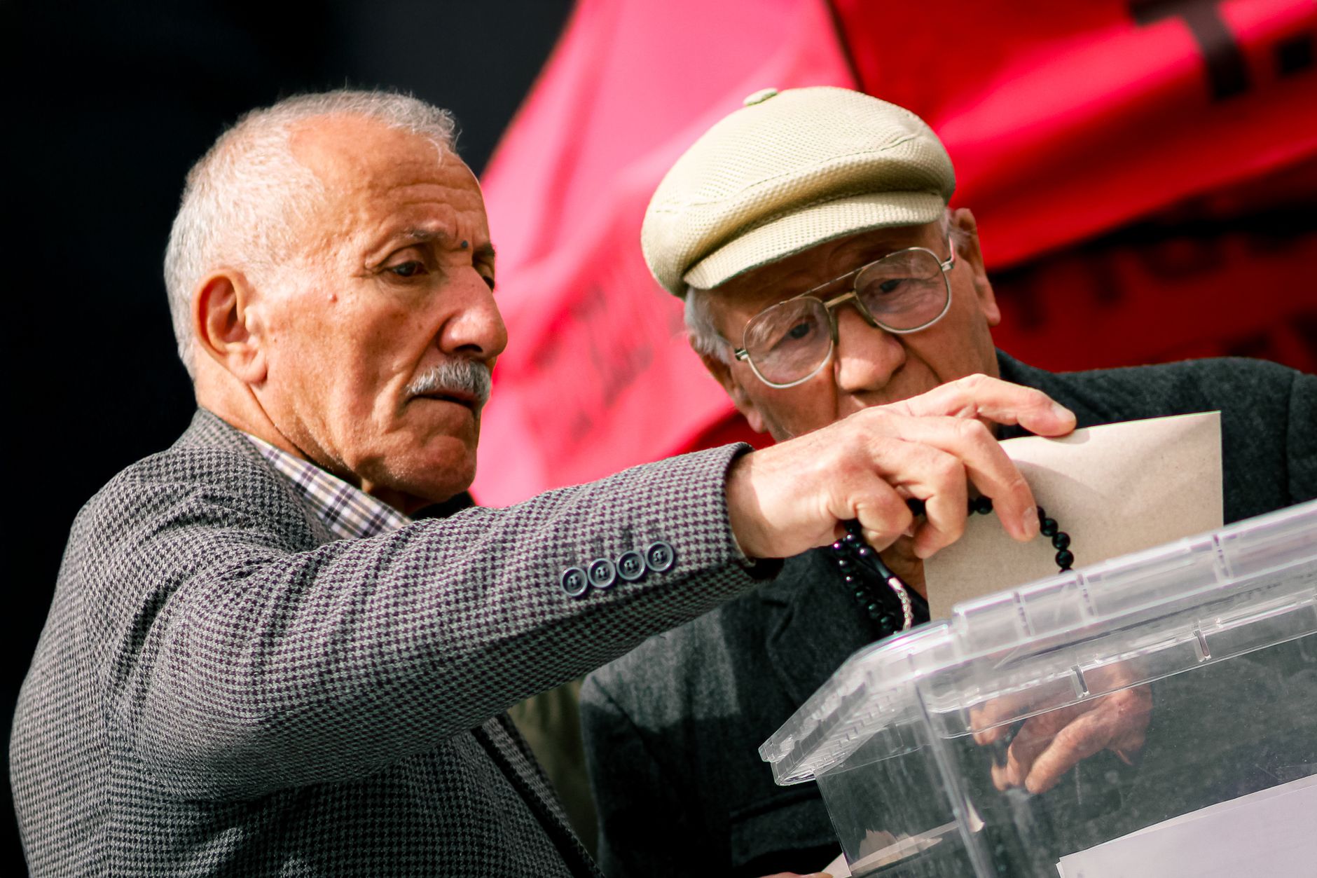 Two senior adults casting their votes at election polls, contributing to democracy.