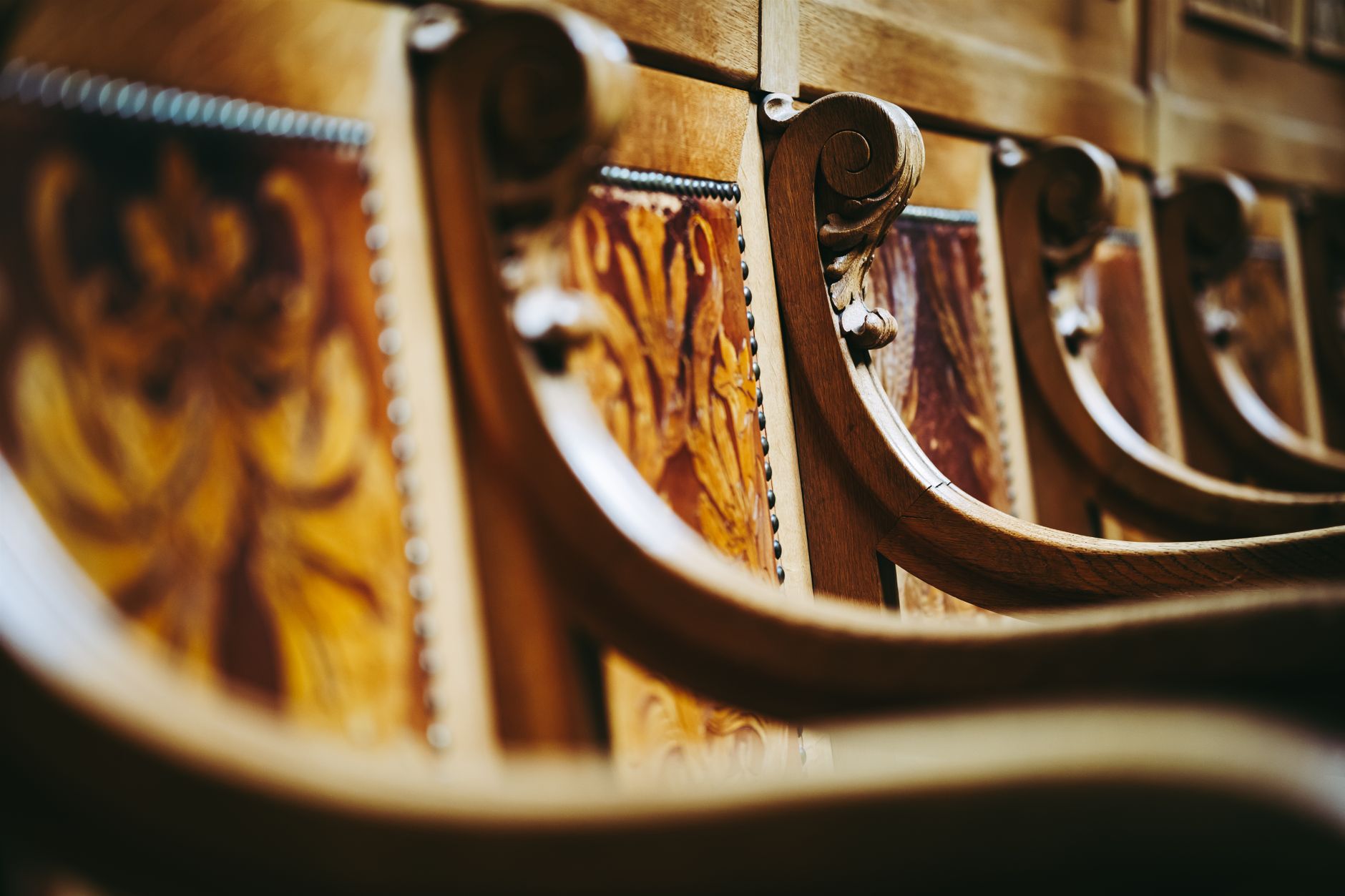 Close-up of ornate wooden chairs inside the Swiss Parliament building in Bern, Switzerland.