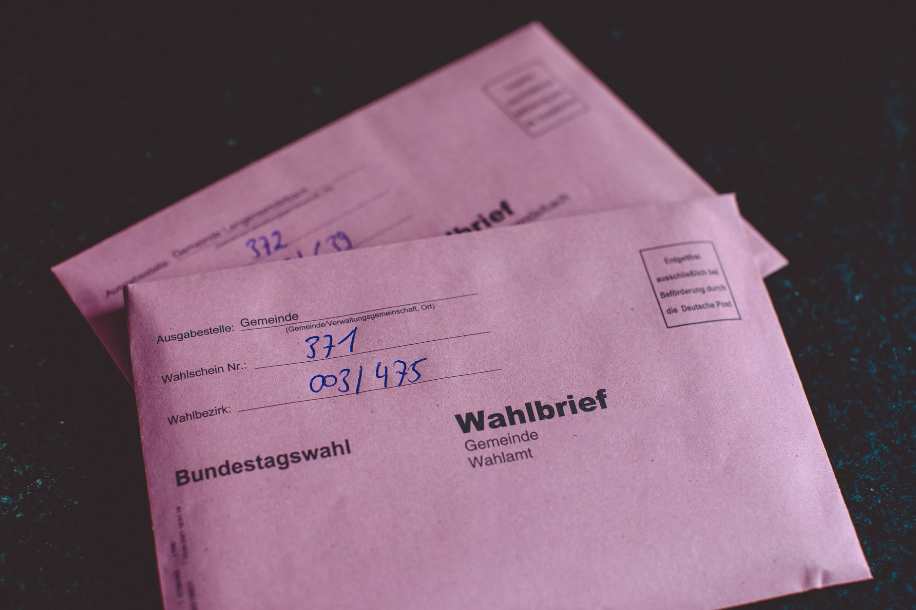Close-up of German election ballot envelopes for the Bundestag election, showcasing voting documents.