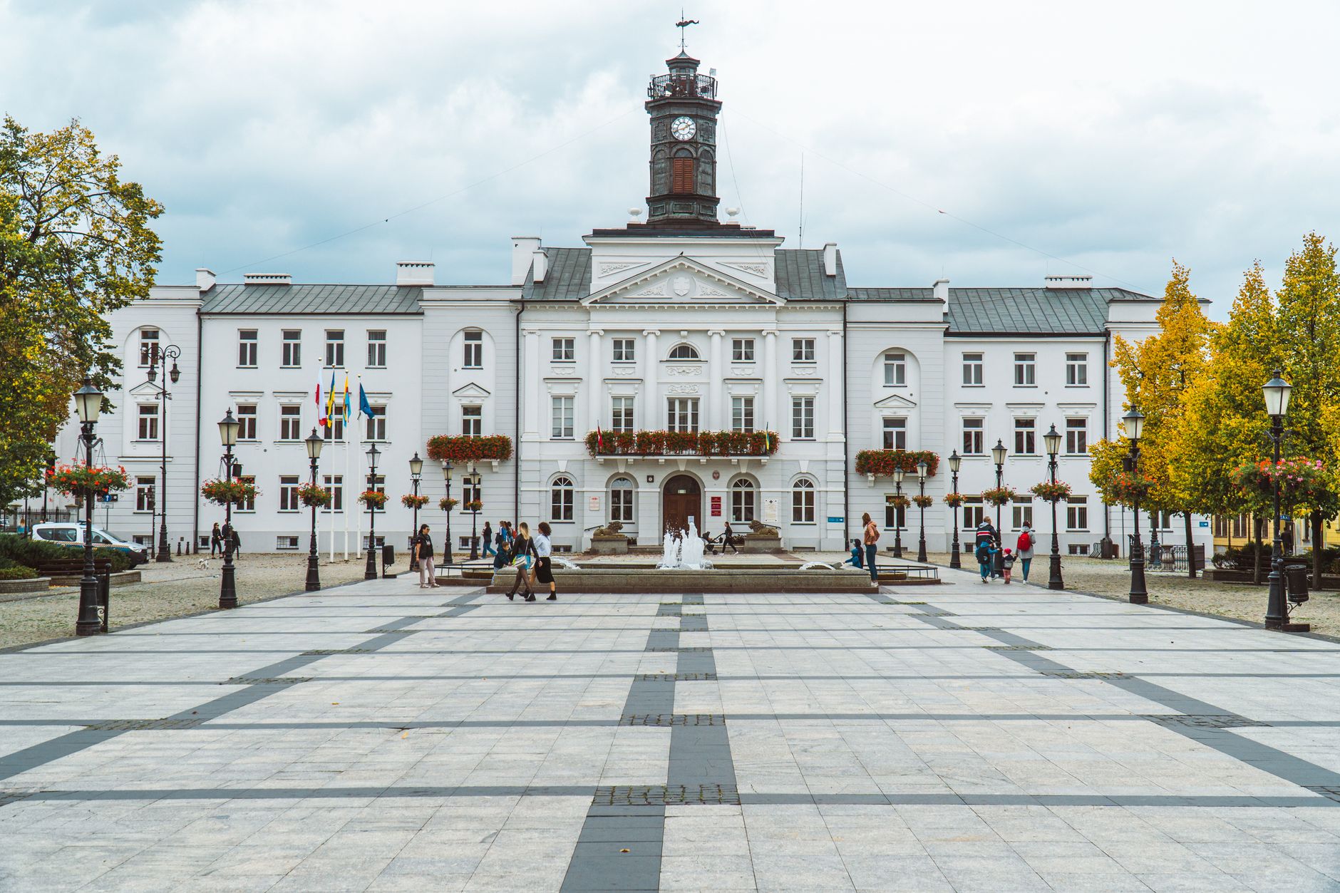 View of the historic town hall in Plock, Poland, showcasing classic architecture and city square.