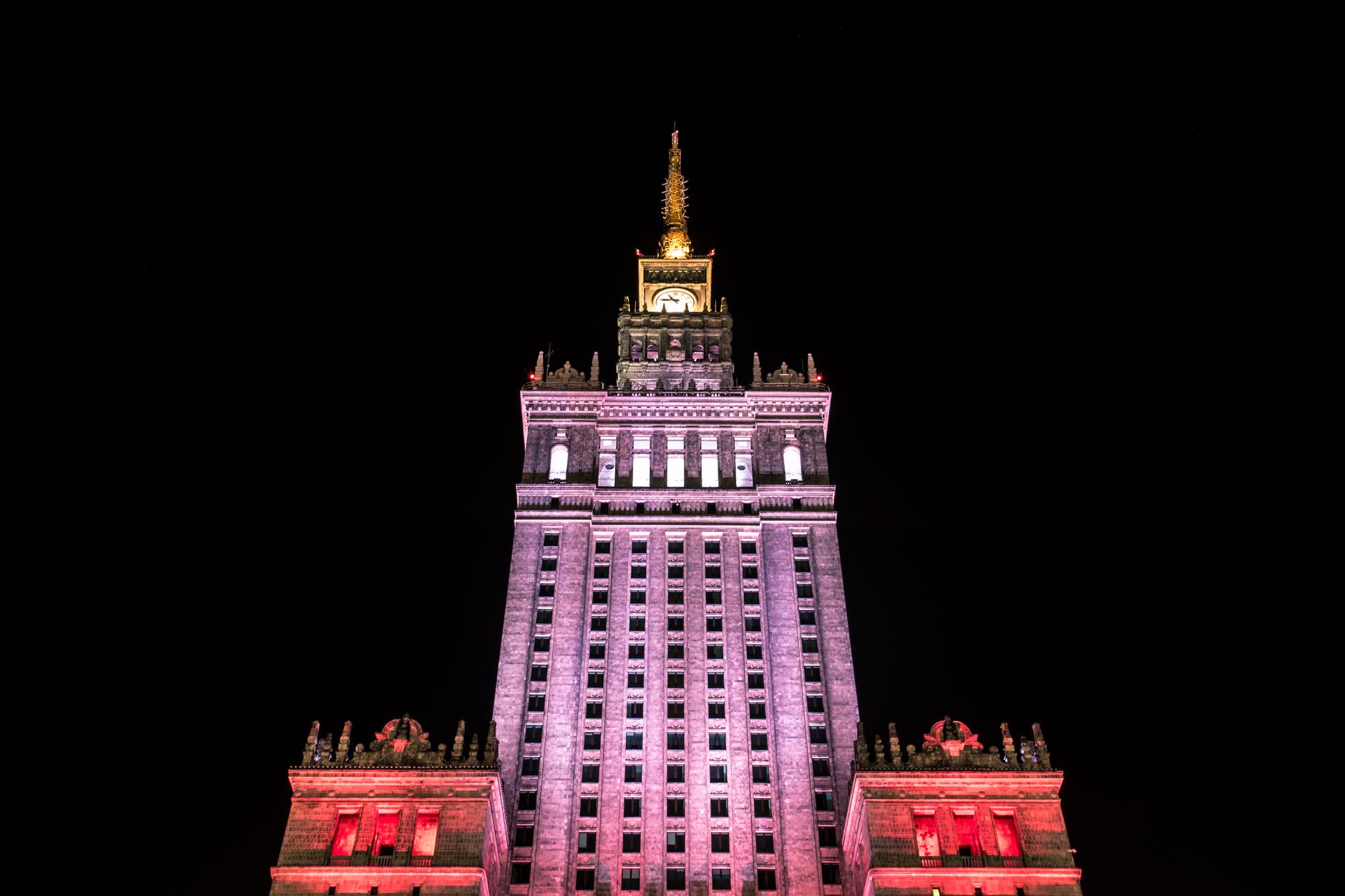 Night shot of the beautifully illuminated Palace of Culture and Science in Warsaw, Poland.