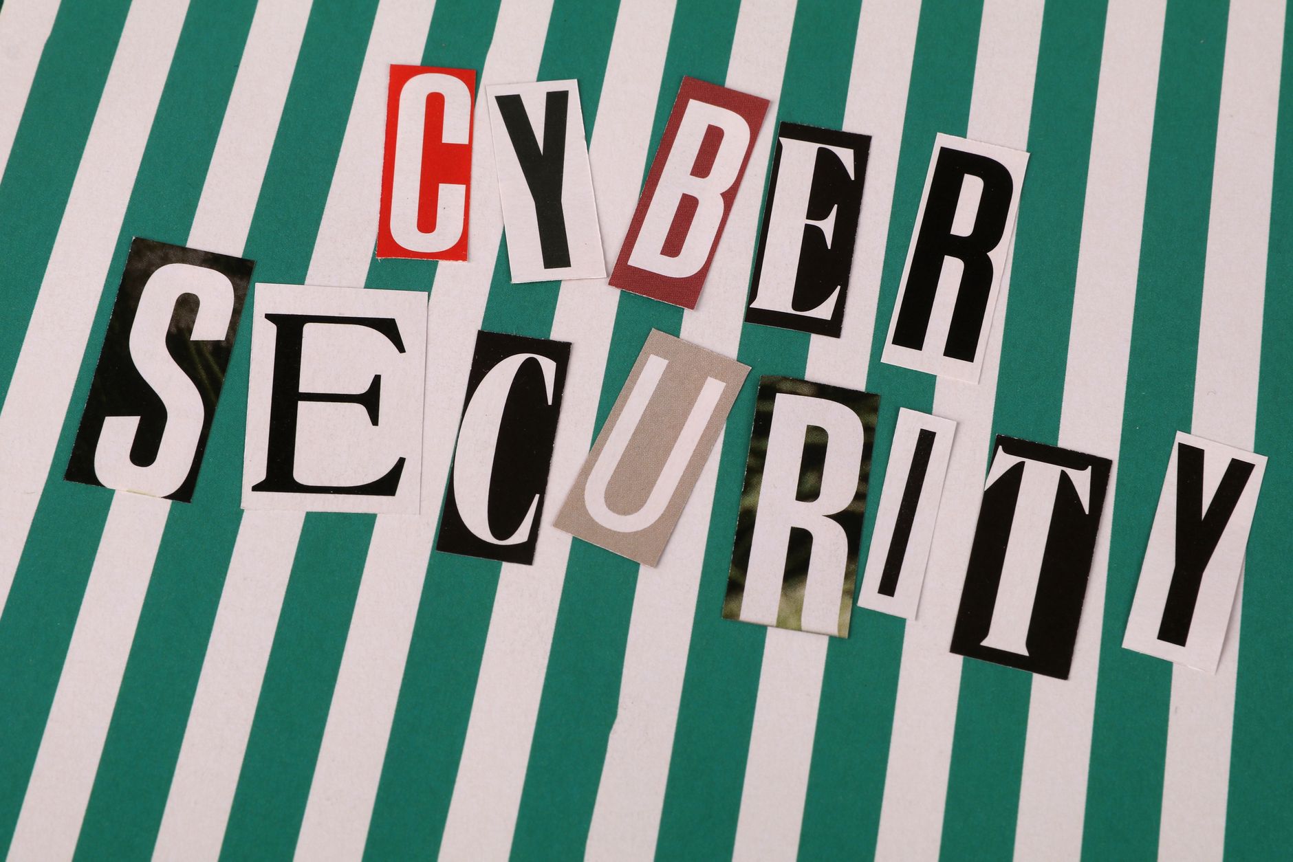 Colorful cutout letters spelling 'Cyber Security' on a striped background.