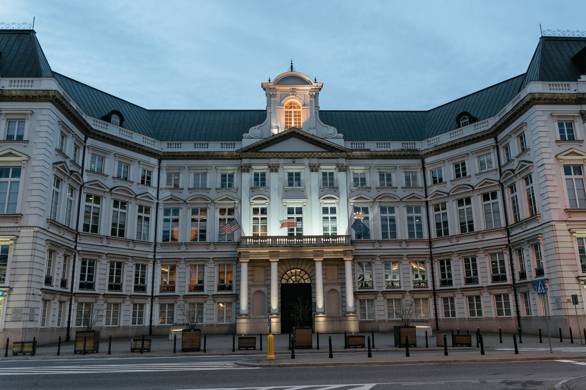 Twilight view of the Renaissance Revival Jablonowski Palace facade with illuminated details.